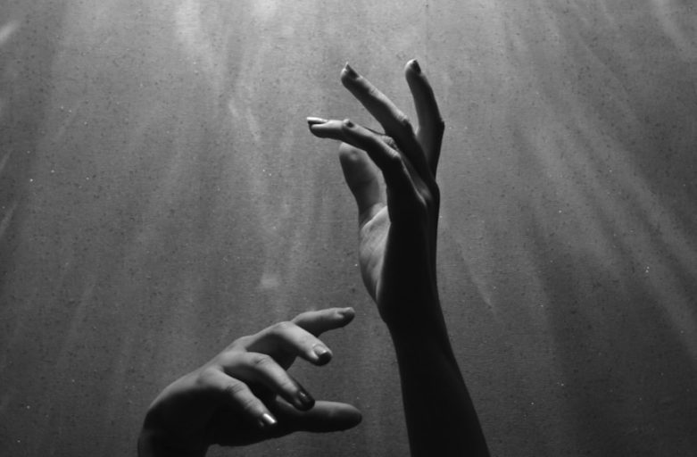 person raising both hands